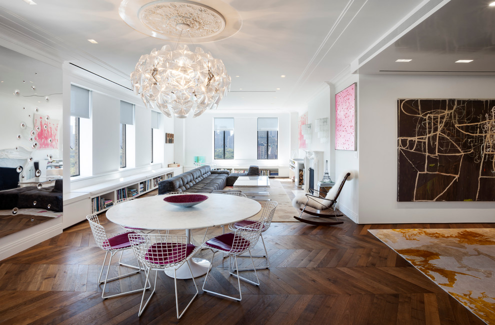 Contemporary open plan dining in New York with white walls and medium hardwood floors.