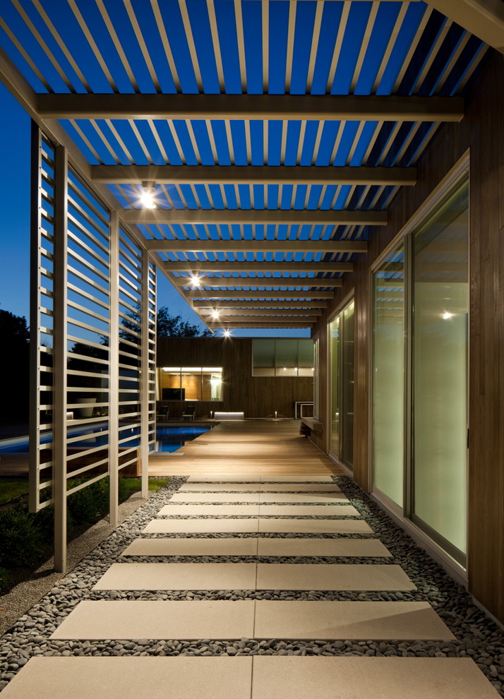 This is an example of a contemporary concrete paver landscaping in Omaha with a pergola.