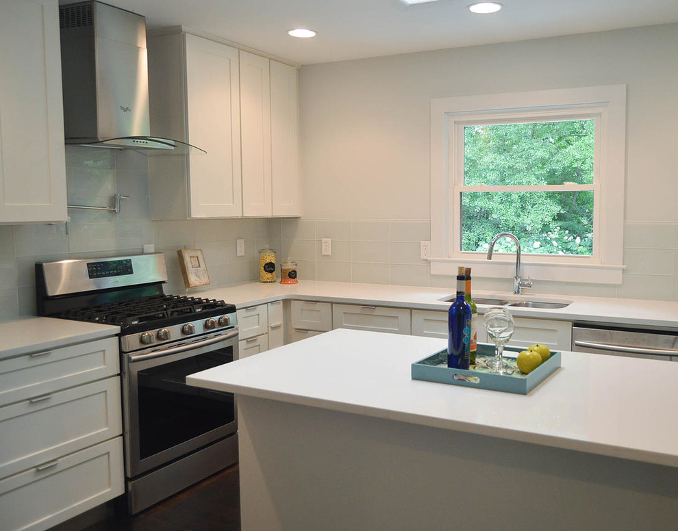 This is an example of a mid-sized modern galley open plan kitchen in Atlanta with an undermount sink, shaker cabinets, white cabinets, quartzite benchtops, yellow splashback, glass tile splashback, stainless steel appliances, dark hardwood floors and with island.