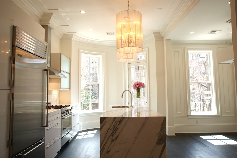 Traditional kitchen in Boston with flat-panel cabinets, white cabinets and marble benchtops.
