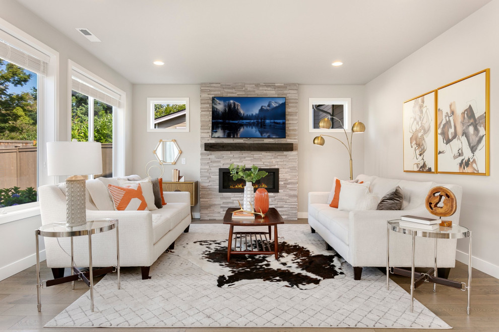 Mid-sized transitional open concept living room in Seattle with beige walls, medium hardwood floors, a ribbon fireplace, a tile fireplace surround, a wall-mounted tv and brown floor.