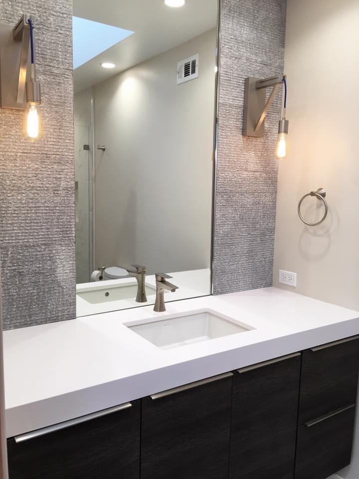 Small contemporary 3/4 bathroom in San Diego with flat-panel cabinets, dark wood cabinets, an alcove shower, a one-piece toilet, gray tile, stone tile, white walls, porcelain floors, an undermount sink and engineered quartz benchtops.