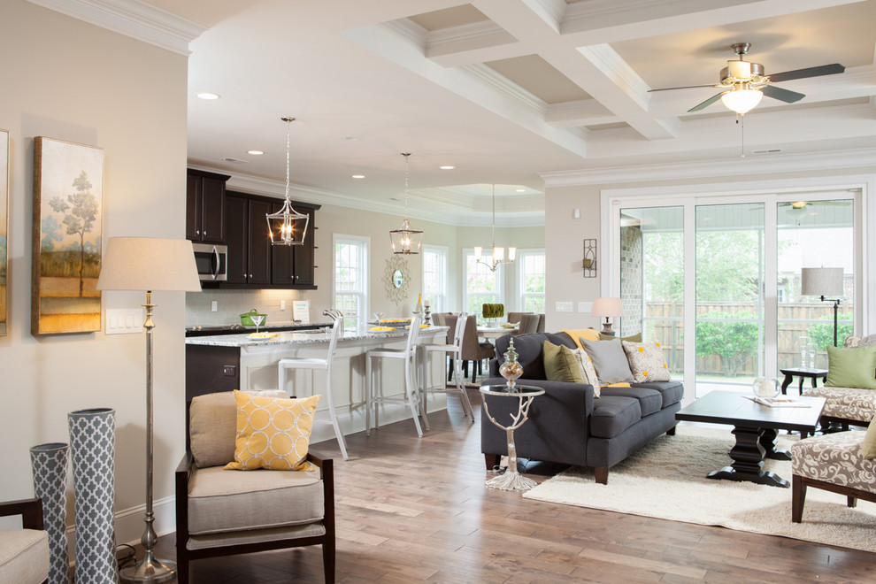 Design ideas for an expansive transitional open concept family room in Raleigh with medium hardwood floors, a corner fireplace and a tile fireplace surround.