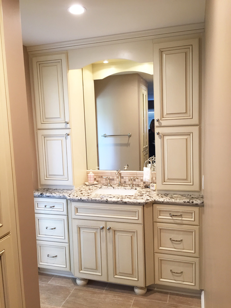 Large mediterranean master bathroom in San Francisco with recessed-panel cabinets, white cabinets, a hot tub, an alcove shower, a one-piece toilet, white tile, porcelain tile, pink walls, ceramic floors, a drop-in sink and granite benchtops.