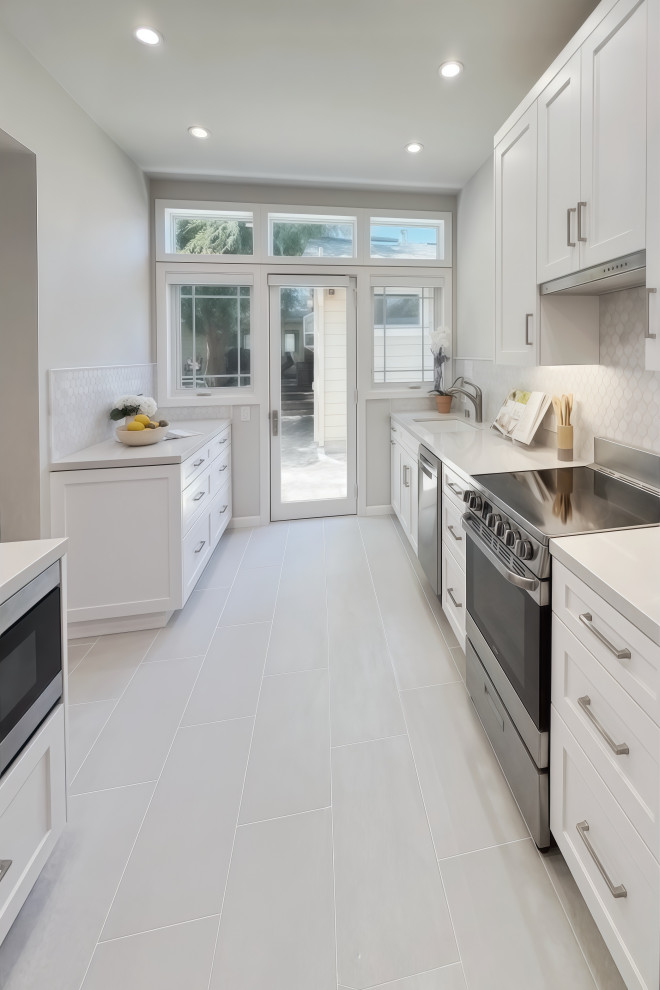 Enclosed kitchen - small transitional galley porcelain tile and gray floor enclosed kitchen idea in San Francisco with an undermount sink, shaker cabinets, white cabinets, quartz countertops, gray backsplash, mosaic tile backsplash, stainless steel appliances and yellow countertops