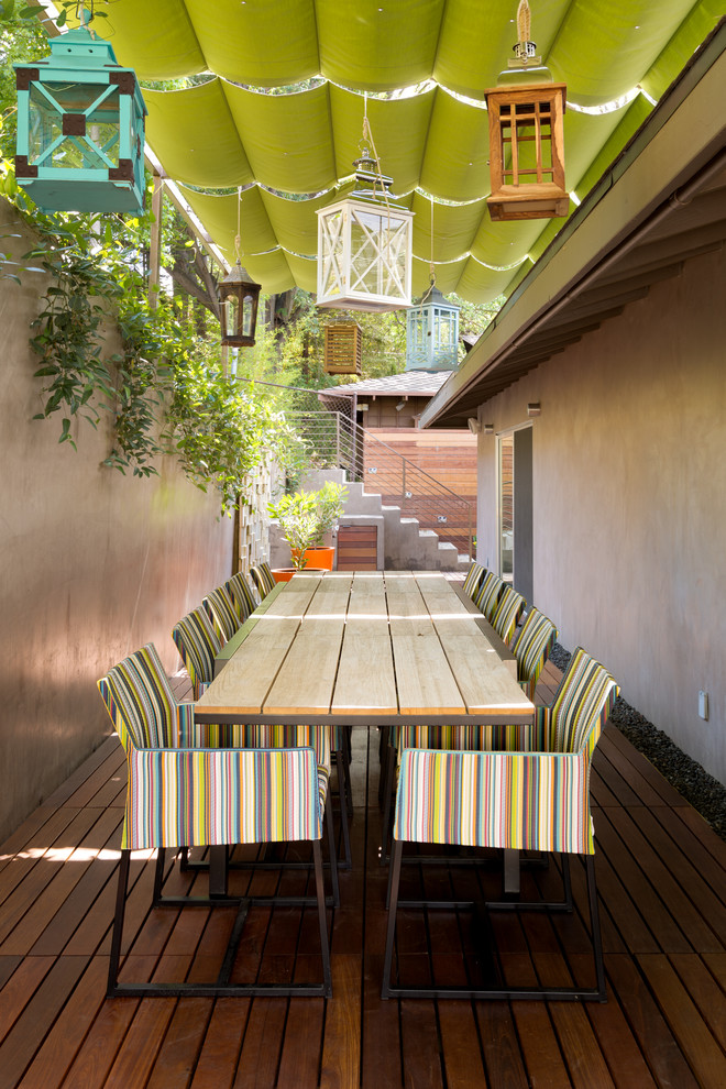 Photo of a contemporary patio in Los Angeles with decking and an awning.