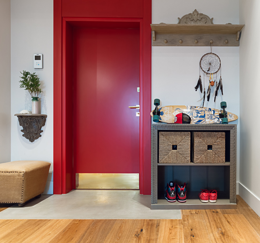 Inspiration for an eclectic front door in Other with white walls, medium hardwood floors, a single front door and a red front door.