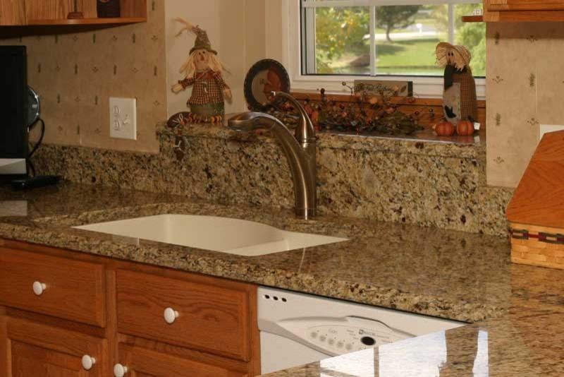 Example of a transitional u-shaped medium tone wood floor kitchen pantry design in Chicago with raised-panel cabinets, medium tone wood cabinets and granite countertops