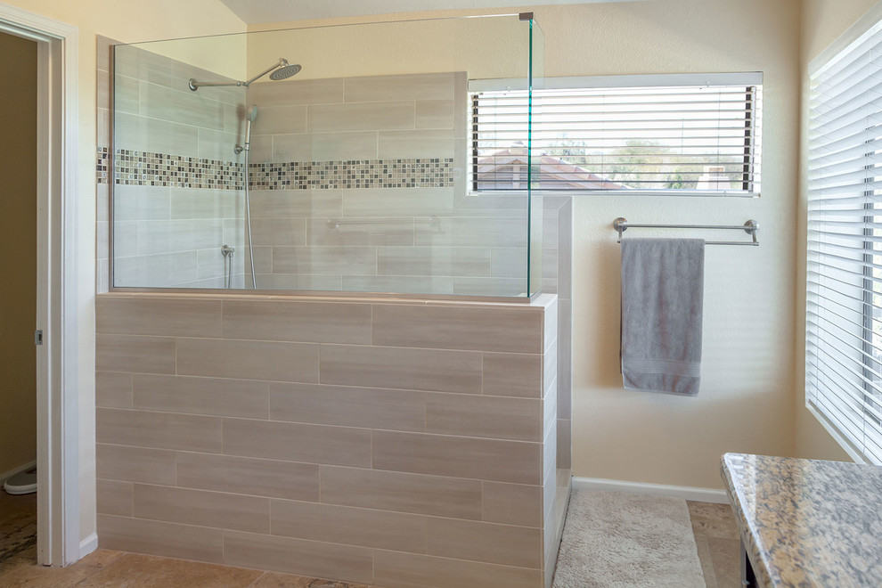 Example of a large transitional master brown tile and porcelain tile ceramic tile walk-in shower design in Phoenix with recessed-panel cabinets, dark wood cabinets, a two-piece toilet, beige walls, an undermount sink and granite countertops