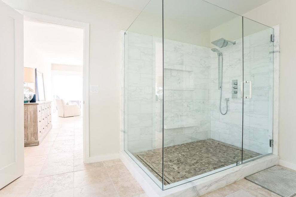 Mid-sized transitional master gray tile and marble tile ceramic tile and beige floor corner shower photo in Orange County with shaker cabinets, white cabinets, gray walls, a drop-in sink, marble countertops, a hinged shower door and white countertops