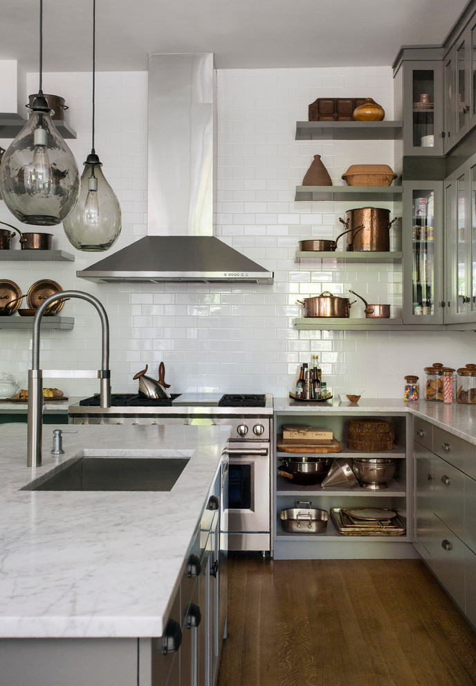 Inspiration for a large transitional l-shaped open plan kitchen in Boston with an undermount sink, flat-panel cabinets, grey cabinets, white splashback, subway tile splashback, stainless steel appliances, dark hardwood floors, with island and marble benchtops.
