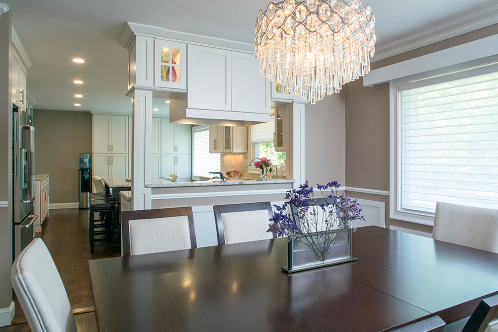 Inspiration for a large transitional galley dark wood floor eat-in kitchen remodel with an undermount sink, shaker cabinets, white cabinets, granite countertops, beige backsplash, stone tile backsplash, stainless steel appliances, brown walls and an island