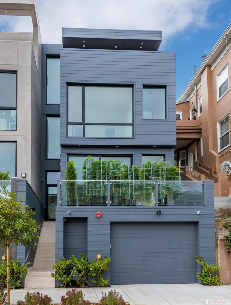 This is an example of a large modern stucco grey house exterior in San Francisco with four or more storeys and a flat roof.