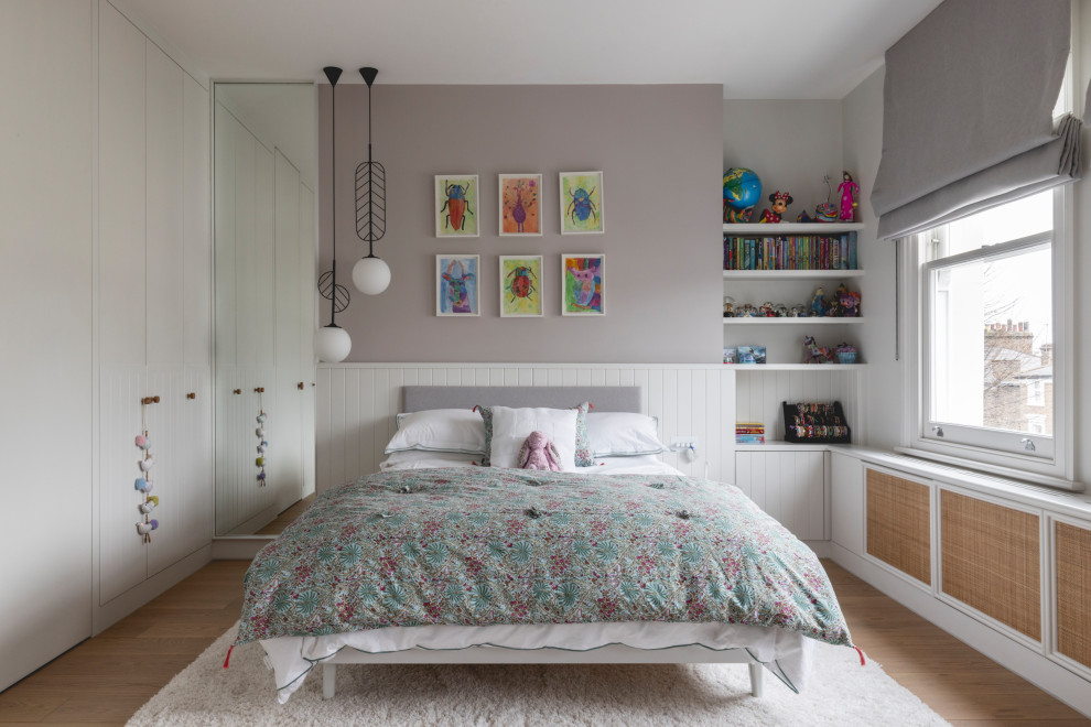 Inspiration for a contemporary kids' bedroom for girls in London with grey walls, light hardwood flooring and brown floors.