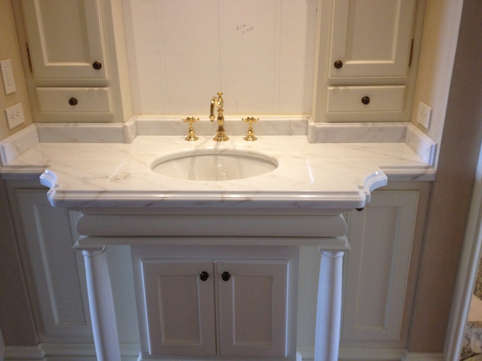 Bathroom - mid-sized transitional 3/4 dark wood floor and brown floor bathroom idea in Denver with recessed-panel cabinets, white cabinets, white walls, an undermount sink, marble countertops and white countertops