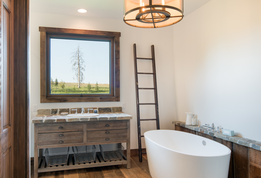 Mountain style bathroom photo with wood countertops