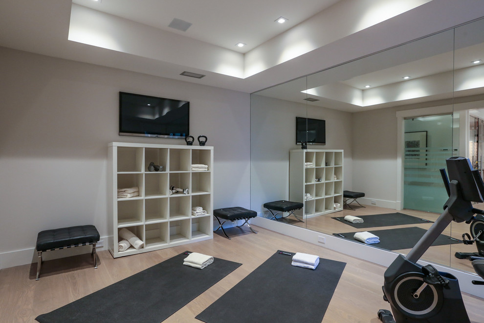 This is an example of a mid-sized contemporary multipurpose gym in San Francisco with grey walls, light hardwood floors and grey floor.