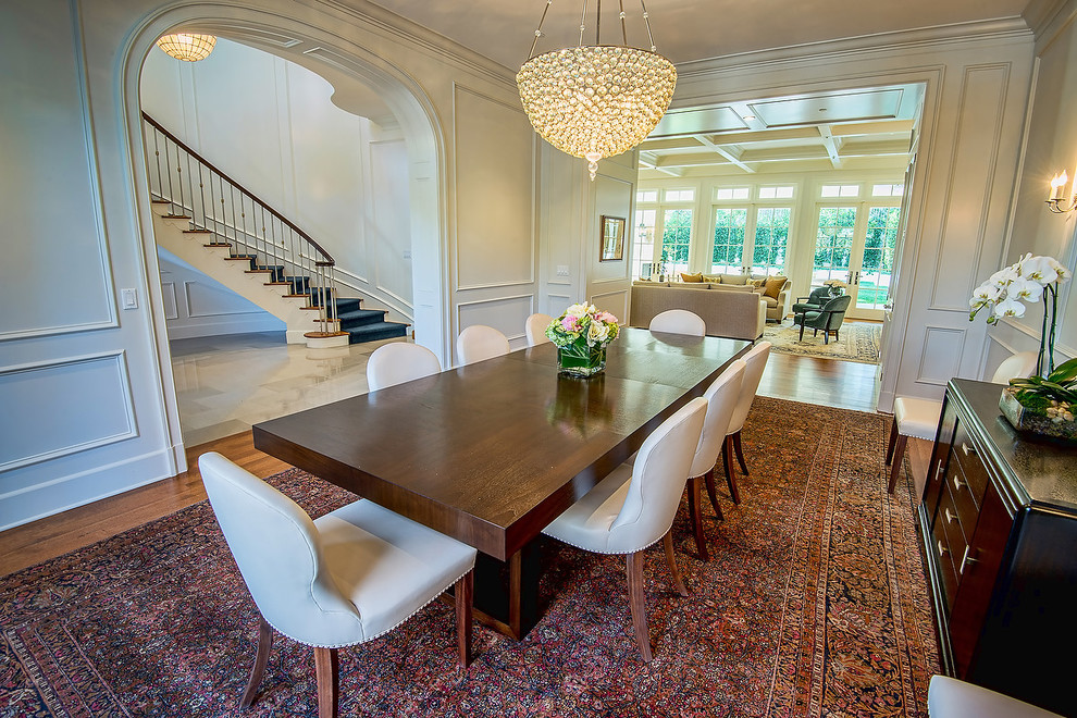 This is an example of a traditional dining room in Los Angeles with white walls and medium hardwood floors.