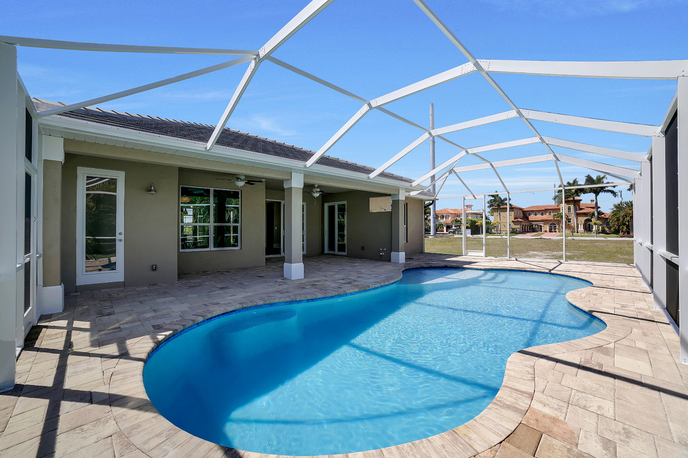 Mid-sized transitional backyard brick and kidney-shaped pool photo