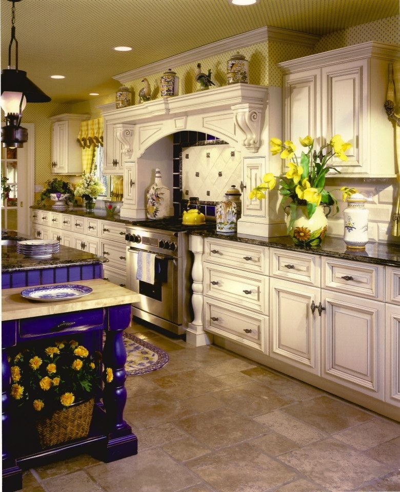 This is an example of a mid-sized traditional galley eat-in kitchen in New York with an undermount sink, raised-panel cabinets, white cabinets, granite benchtops, beige splashback and limestone floors.