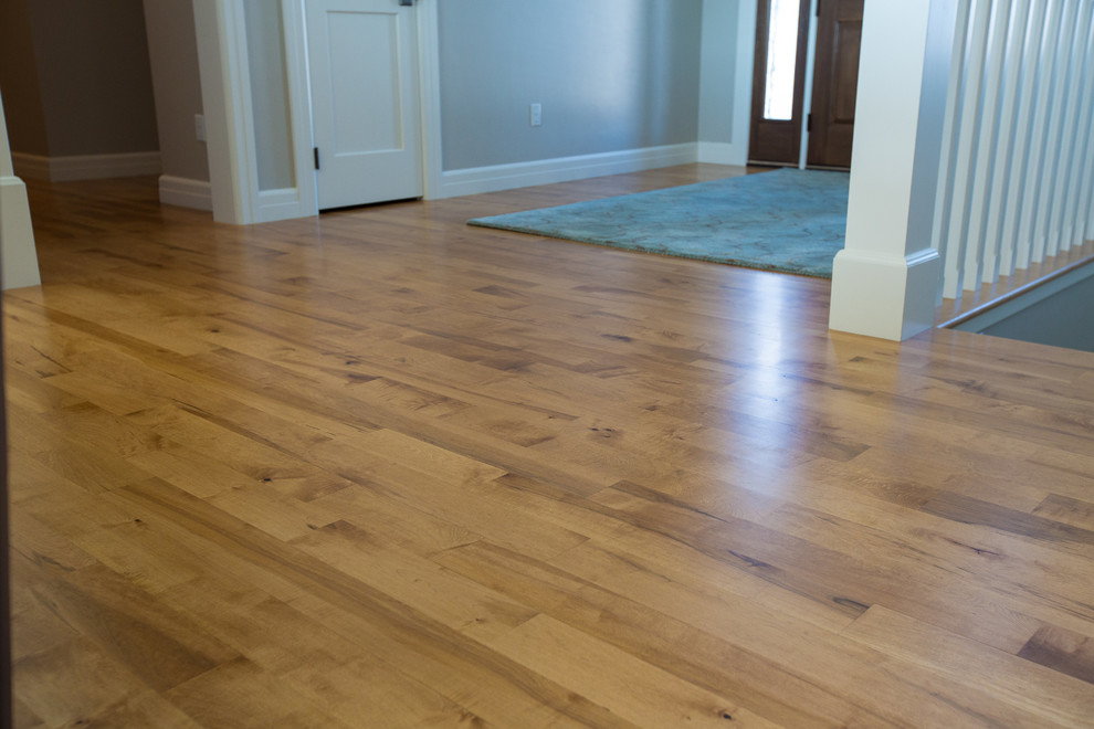 Inspiration for a mid-sized transitional medium tone wood floor and brown floor hallway remodel with beige walls