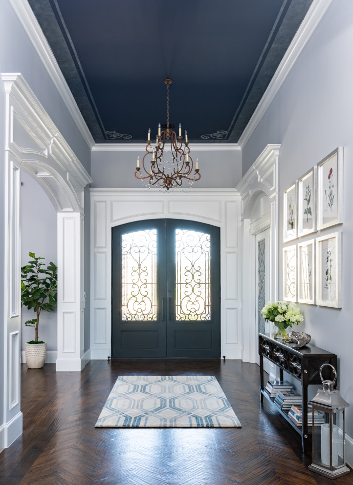 Design ideas for a mid-sized transitional foyer in Dallas with grey walls, dark hardwood floors, a double front door, a metal front door, brown floor, wallpaper and wallpaper.