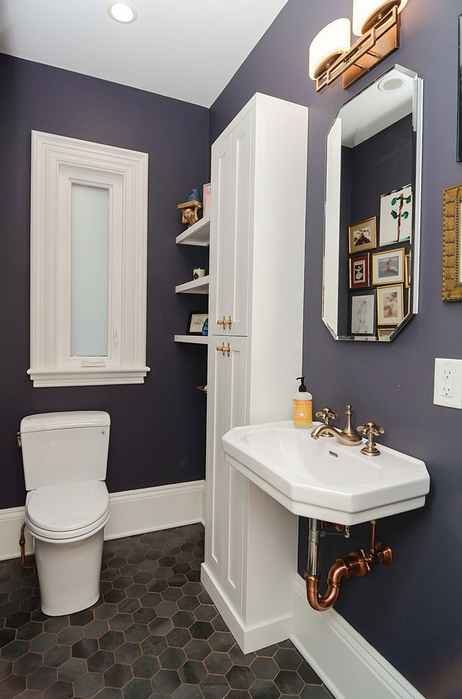 Small transitional powder room in Boston with shaker cabinets, white cabinets, a two-piece toilet, purple walls, porcelain floors, a wall-mount sink and grey floor.
