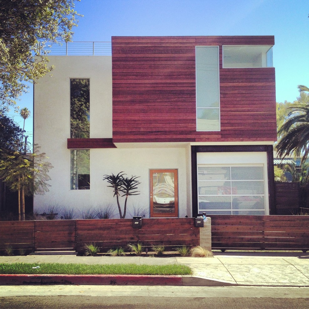 Design ideas for a modern two-storey white exterior in Los Angeles with wood siding.