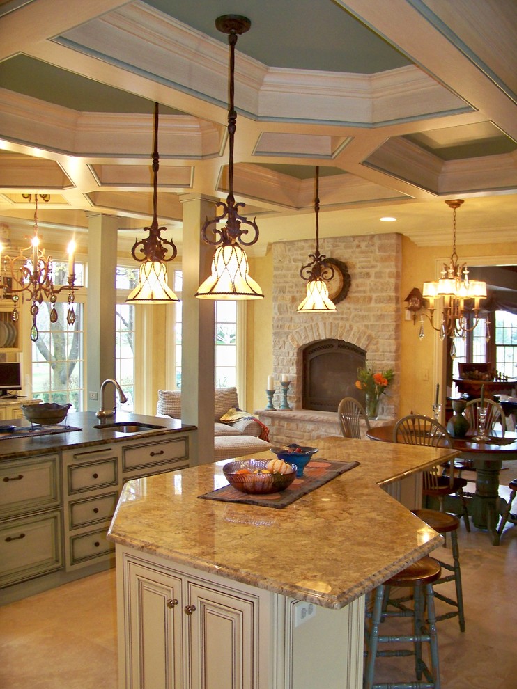 Photo of an expansive eclectic eat-in kitchen in Chicago with raised-panel cabinets, yellow cabinets, granite benchtops, porcelain splashback, coloured appliances, travertine floors and multiple islands.