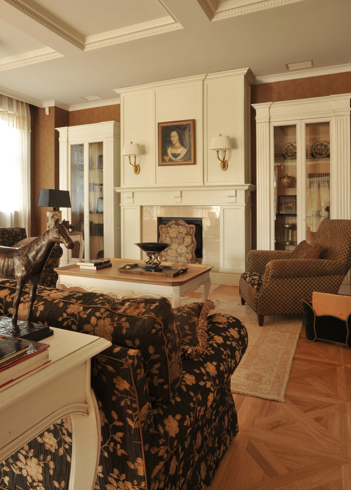 Photo of a large traditional enclosed living room in Moscow with brown walls, medium hardwood floors, a standard fireplace, a plaster fireplace surround, no tv and brown floor.