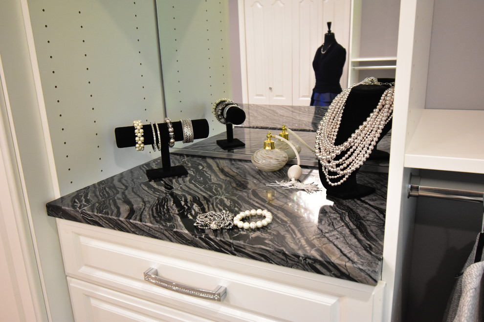 Inspiration for an expansive transitional gender-neutral dressing room in Cleveland with raised-panel cabinets, white cabinets, carpet and beige floor.