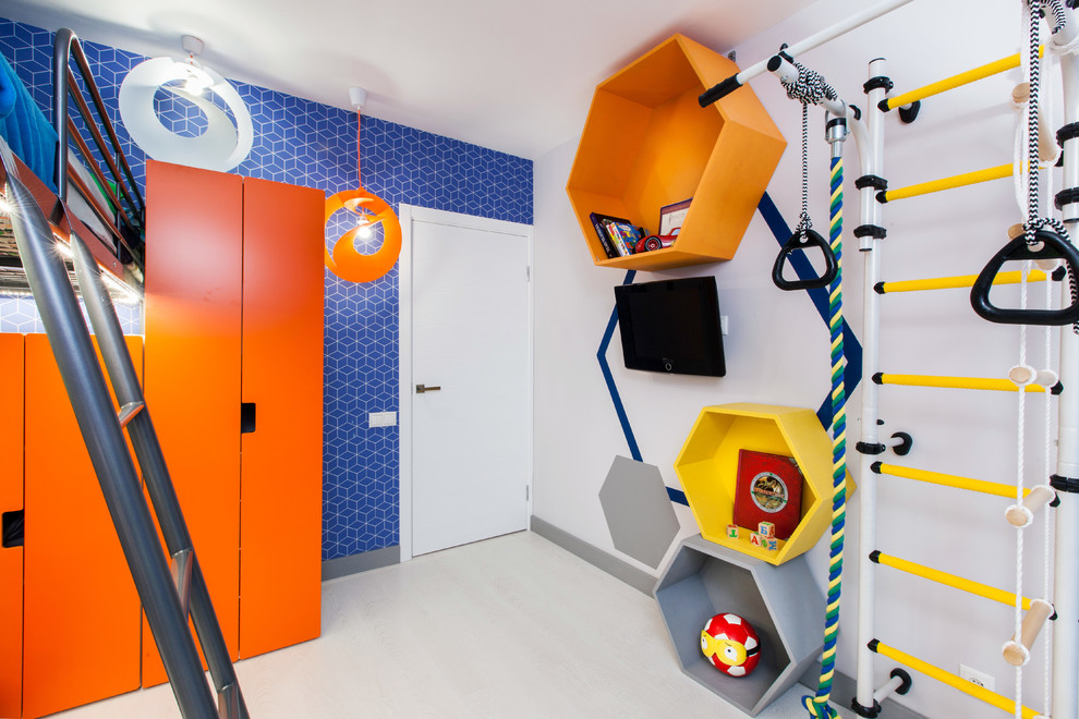 Photo of a small contemporary kids' playroom for kids 4-10 years old and boys in Moscow with blue walls and light hardwood floors.
