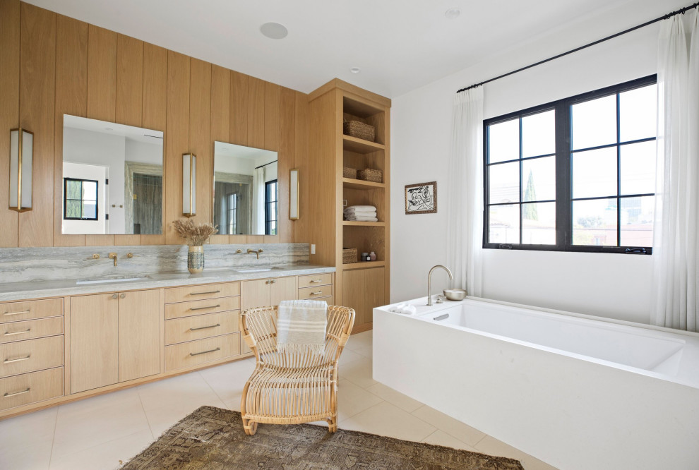 This is an example of a large transitional master wet room bathroom in Los Angeles with recessed-panel cabinets, beige cabinets, a freestanding tub, a one-piece toilet, white tile, travertine, white walls, limestone floors, an undermount sink, limestone benchtops, beige floor, a hinged shower door, grey benchtops, a shower seat, a double vanity, a built-in vanity and coffered.