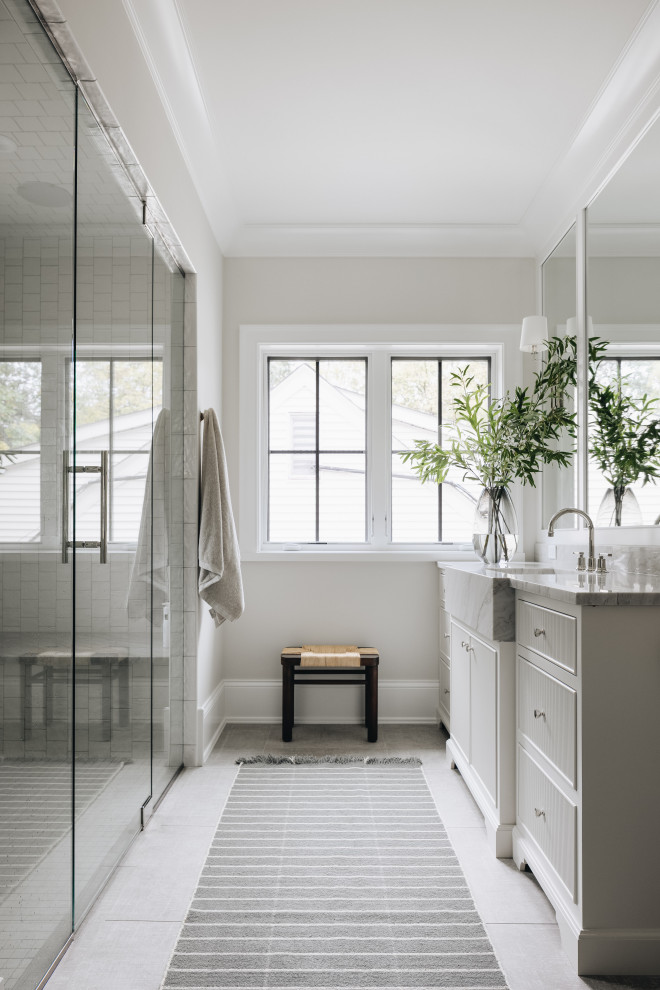 Large transitional master white tile gray floor and single-sink bathroom photo in Chicago with white cabinets, a one-piece toilet, beige walls, a drop-in sink, a hinged shower door, multicolored countertops, a built-in vanity and flat-panel cabinets