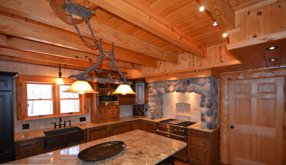 Inspiration for a large rustic l-shaped medium tone wood floor enclosed kitchen remodel in Orange County with a farmhouse sink, marble countertops, white backsplash, stainless steel appliances, an island, raised-panel cabinets, medium tone wood cabinets and stone tile backsplash