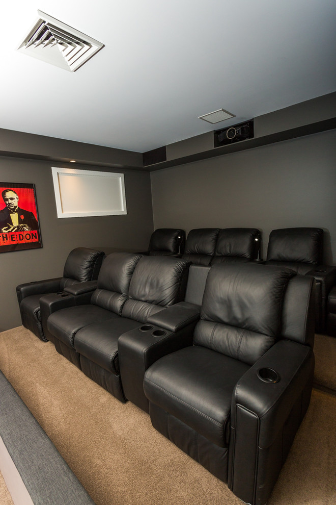 Large home theatre in Sydney with brown walls, carpet and a projector screen.