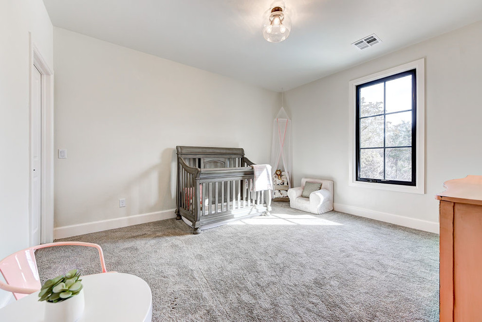 Mid-sized transitional nursery in Oklahoma City with grey walls, carpet and grey floor for girls.