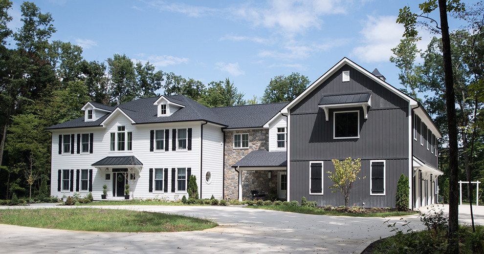 Photo of a large country two-storey grey house exterior in Indianapolis with mixed siding, a hip roof and a shingle roof.