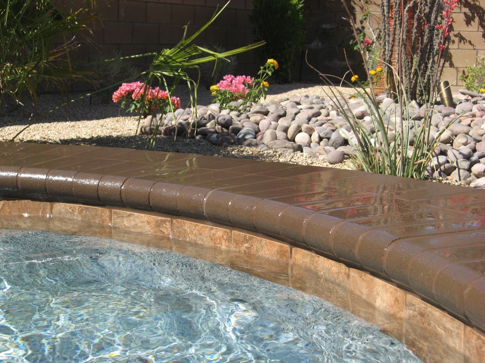 Example of a backyard concrete paver pool design in Orange County