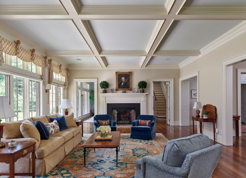 Photo of a traditional formal open concept living room in Philadelphia with beige walls, medium hardwood floors, a standard fireplace, no tv and coffered.