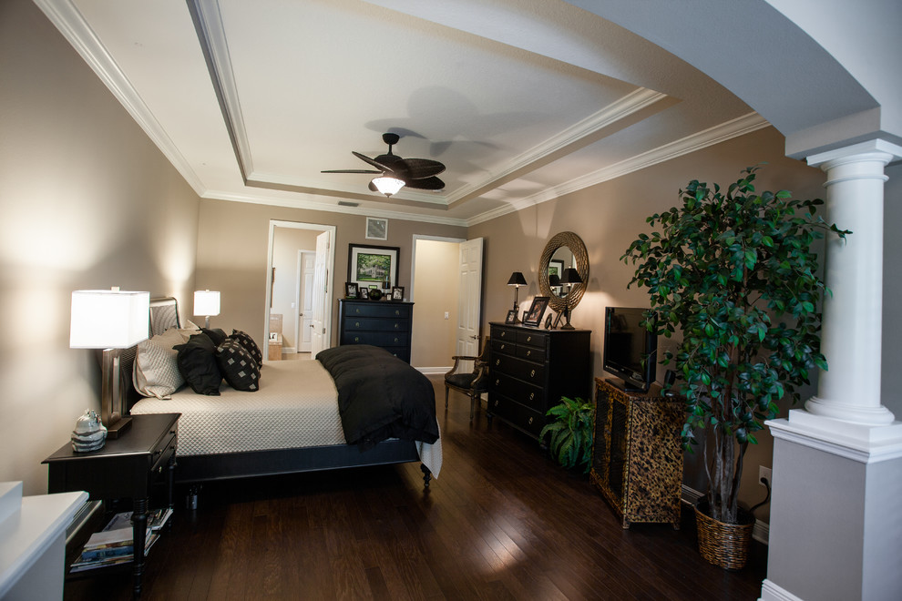 Design ideas for a large traditional master bedroom in Tampa with beige walls.