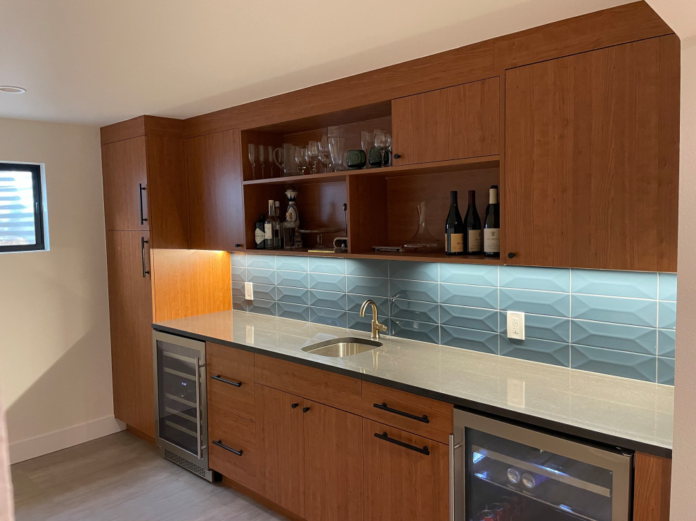 Large midcentury single-wall wet bar in Denver with open cabinets, medium wood cabinets, blue splashback and cement tile splashback.