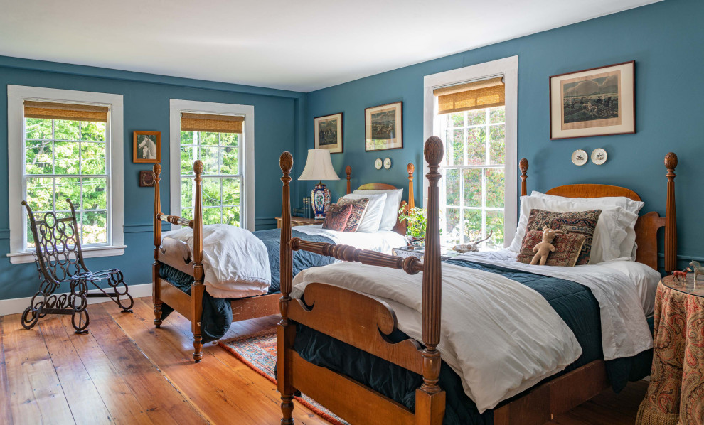 Inspiration for a country guest bedroom in Boston with blue walls and medium hardwood floors.