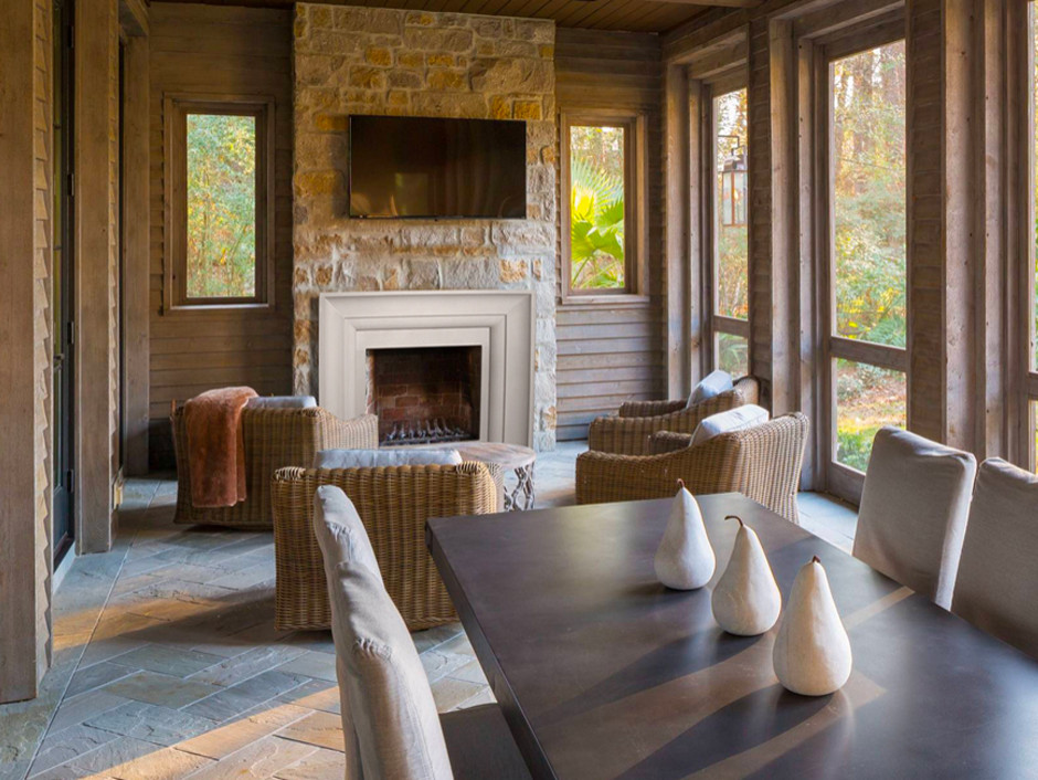 This is an example of a family room in Oklahoma City with a standard fireplace, a stone fireplace surround and yellow floor.