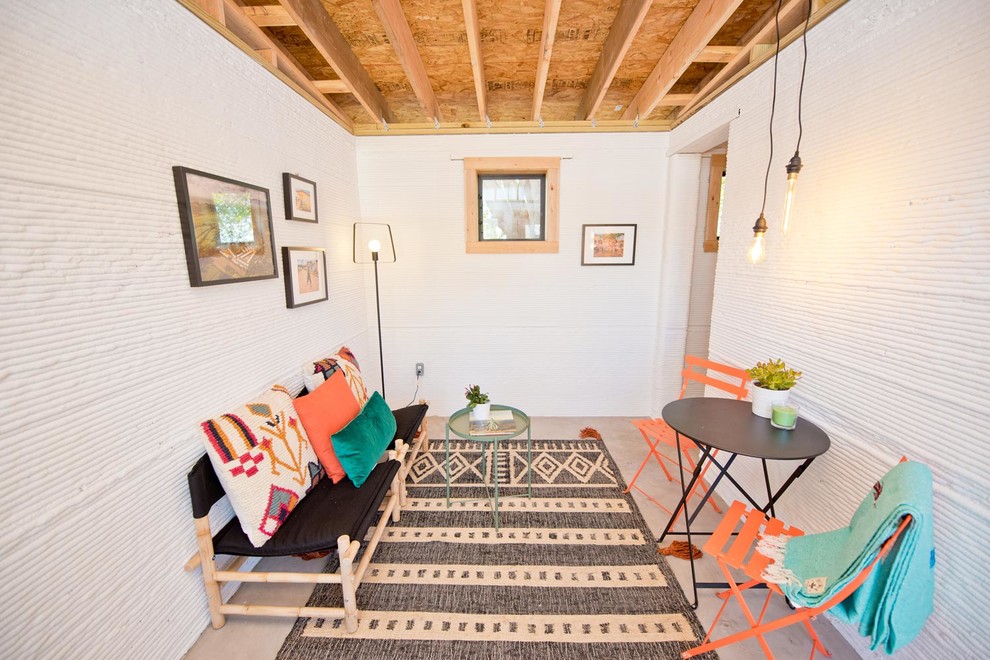 Example of a mid-sized urban living room design in Austin with white walls and no fireplace