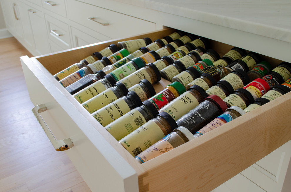Kitchen pantry - large scandinavian u-shaped light wood floor kitchen pantry idea in Cleveland with an undermount sink, white cabinets, quartzite countertops, white backsplash, ceramic backsplash, stainless steel appliances, an island and white countertops