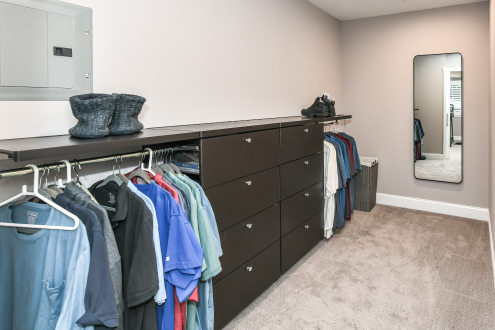 Inspiration for a large traditional gender-neutral walk-in wardrobe in DC Metro with carpet, beige floor, flat-panel cabinets and dark wood cabinets.