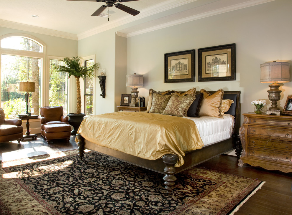 Photo of a transitional master bedroom in Houston with blue walls and medium hardwood floors.