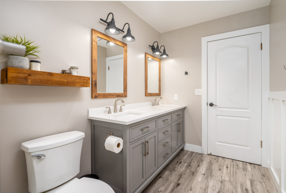 Inspiration for a mid-sized country bathroom in Salt Lake City with grey cabinets, an alcove tub, a shower/bathtub combo, gray tile, porcelain tile, a trough sink, engineered quartz benchtops, grey floor, a sliding shower screen, white benchtops, a double vanity and decorative wall panelling.