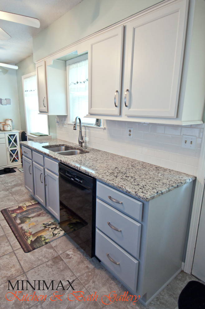 Enclosed kitchen - small transitional galley porcelain tile enclosed kitchen idea with an undermount sink, shaker cabinets, gray cabinets, granite countertops, white backsplash, subway tile backsplash and black appliances